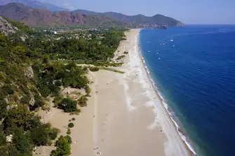 The pebbly Olympos Beach, home to the Eternal Flame, has a real Boho vibe