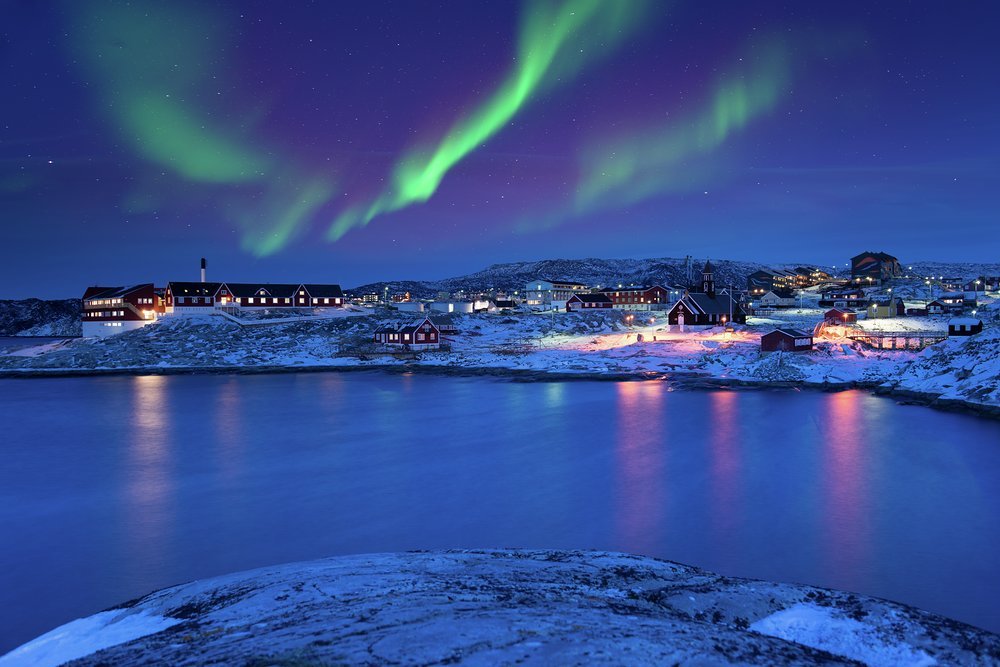 Aurora Borealis illuminating the night sky above the Ilulissat Icefjord