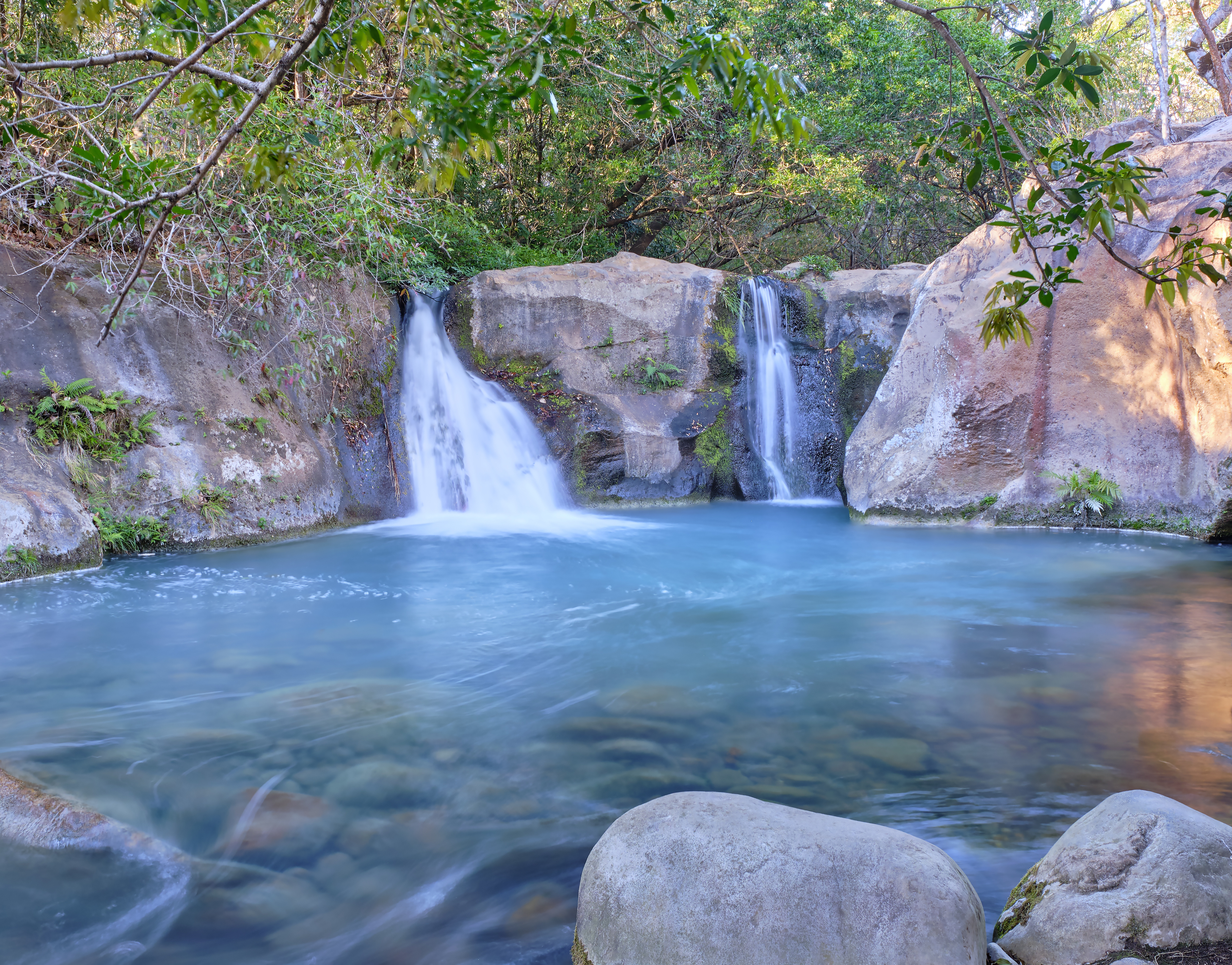 In the rainforest near Rincon National Park, the twin Las Chorreras Waterfalls and the beautiful blue lagoon