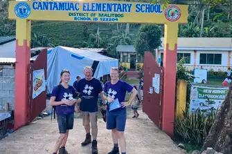 Burgess is so proud of Julie, Andrew and Marie (l-r) for taking up the challenge to help build a school in the Philippines