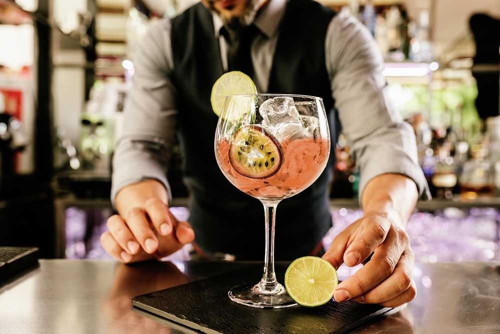 Barman is making cocktail at night club