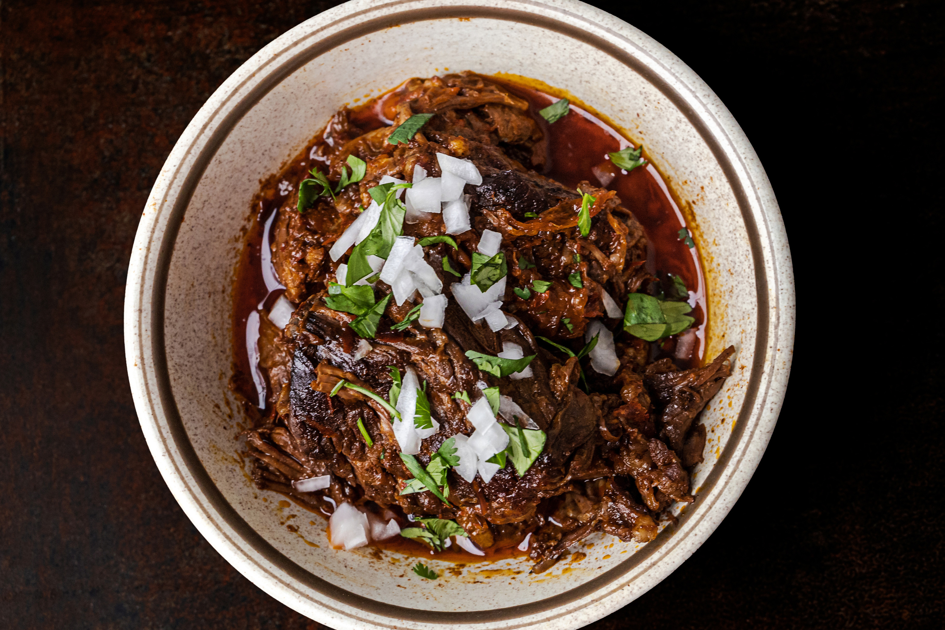 A bowl of slow cooked and braised birria meat