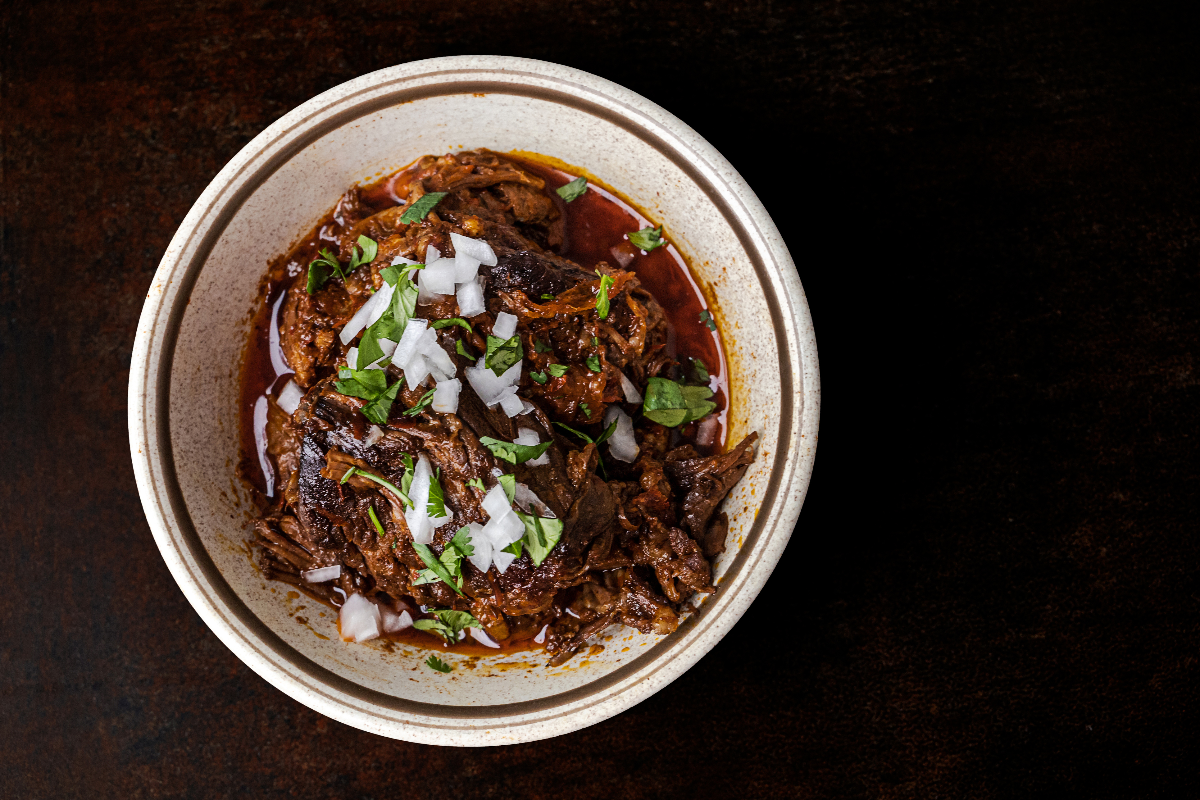 A bowl of slow cooked and braised birria meat