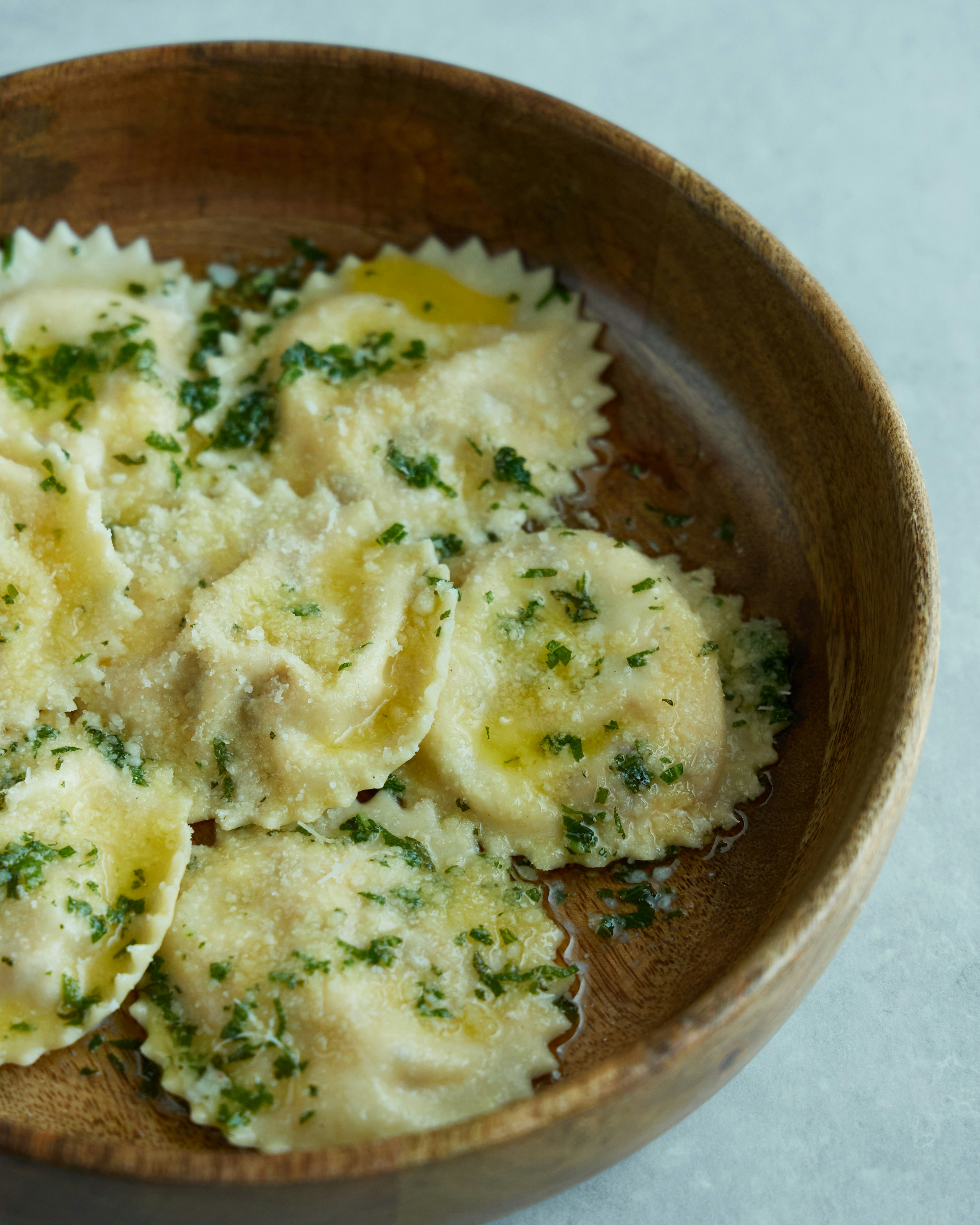 A wooden bowl filled with freshly cooked pasta ravioli