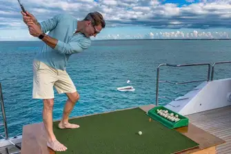 While you're waiting for the match to start, you can practice your swing while feeding the fish with biodegradable fish-food golf balls