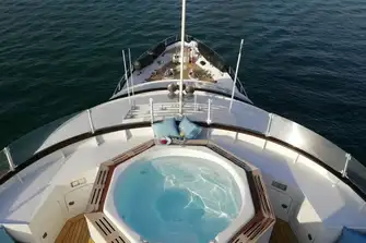 Her jacuzzi is screened from the breeze and overlooks the foredeck