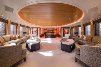 Looking forward in the main saloon. The lounge aft turns into a cinema room with projector and screen and there is a formal dining area past the piano lounge