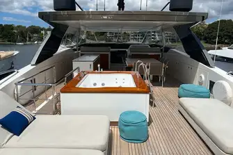 The aft sun deck with sun loungers and the teak-capped jacuzzi