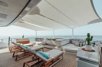 The sun deck aft has a pool surrounded by sunpads and sunlounging
