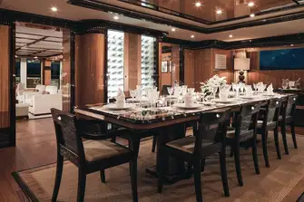 The main deck's formal dining area with wine cellar, forward of the main saloon