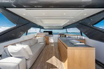 Beneath the hardtop with sun roof is a wet bar, buffet bar for open-air dining and a flybridge helm station