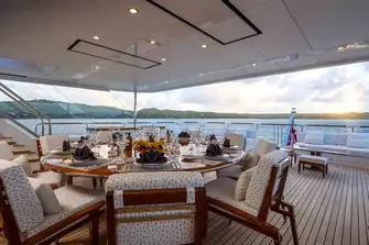 Open-air dining in a large entertainment space on the upper deck aft