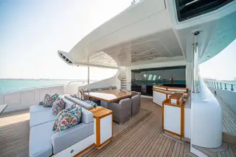 Open-air dining and a sun lounge on the main deck aft