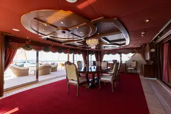 Formal dining on the bridge deck aft with terrace and bar outside