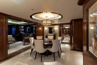 Forward of the main deck cinema room is a formal dining room and a library with an electric fireplace