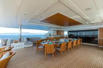 Open-air dining with bar and sun lounge on the upper deck aft