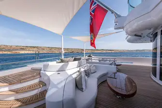 TALISMAN C - Seating, sunpads and steps to the beach club on the main deck aft