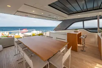 The bar and dining area's sunroof delivers light or shade as required. There is plenty of versatile deck space aft and a flybridge out of shot to the right