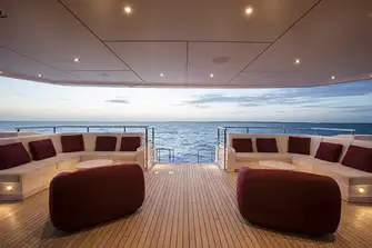 Banquette seating on the main deck aft with steps leading down to the swim platform
