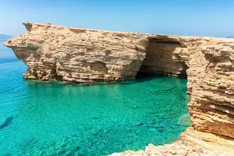 Stunning waters surround the Ksylobatis Caves on Ano Koufonisi in the southern Cyclades
