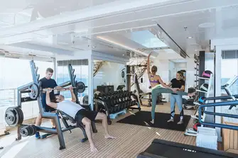 Workout with a personal trainer in an air-conditioned gym