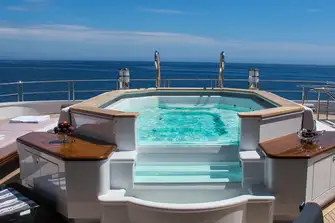 Find the glass-fronted jacuzzi on the spacious sun deck