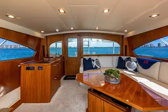 Aft of the enclosed bridge lounge there is lounge seating and a helm station