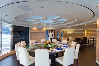 The upper deck dining room with wraparound views and the skylight above