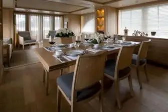 The dining area with the main saloon beyond and open-air dining on the aft deck