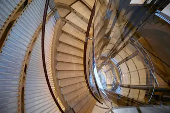 Spiral stairs around the steel and glass elevator