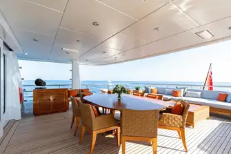 Open-air dining and a sun lounge on the bridge deck aft