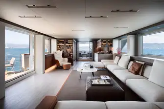 Looking aft in the main saloon with its folding balcony and open air lounge area aft