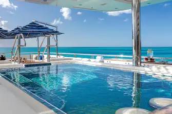 A large sun deck pool with swim-up bar...