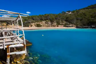 Beautiful turquoise water laps the pebbles at Cala Benirras