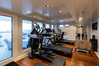 The climate controlled gym overlooks the large pool on the bridge deck aft
