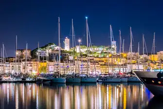 Cannes Vieux Port packed with yachts and overlooked by Notre-Dame de l'Esperance