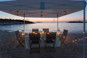 After a day's fun on the water, feel the sand between your toes dining on a secluded beach