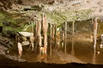Escape the heat of the day by exploring the caves of Can Marçà