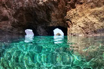 Dive or snorkel to explore the Dragonisi Caves in Mykonos